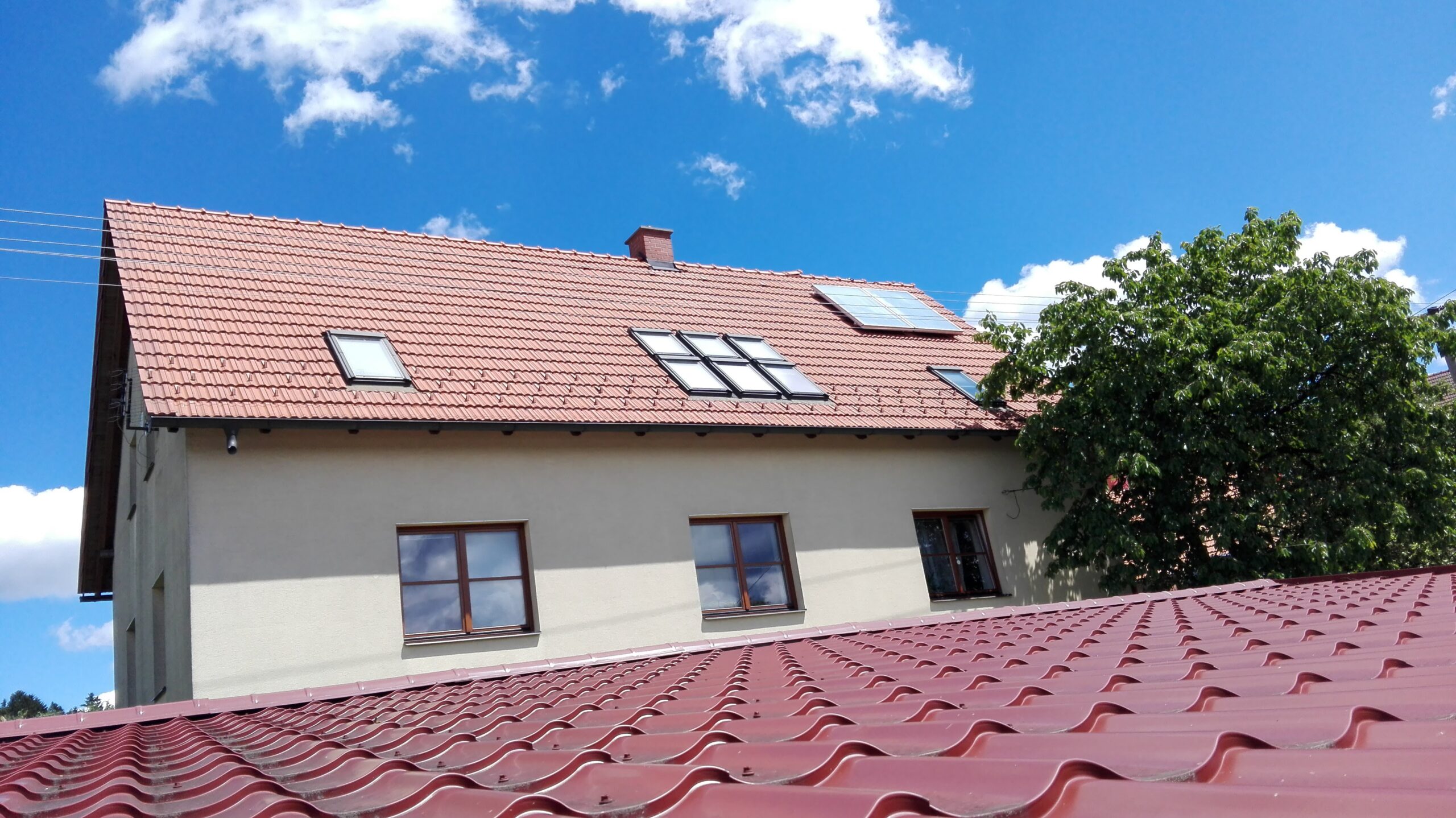 Dům s červenou střechou a okny.